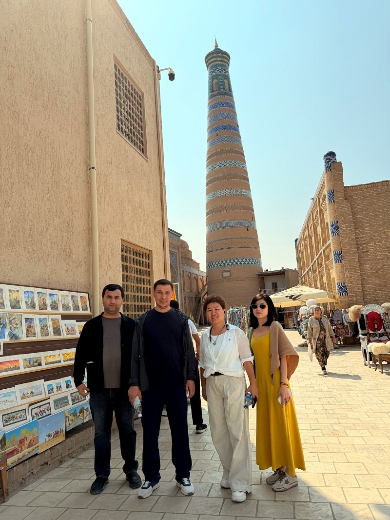Wonear team in front of historic tower in Kazakhstan